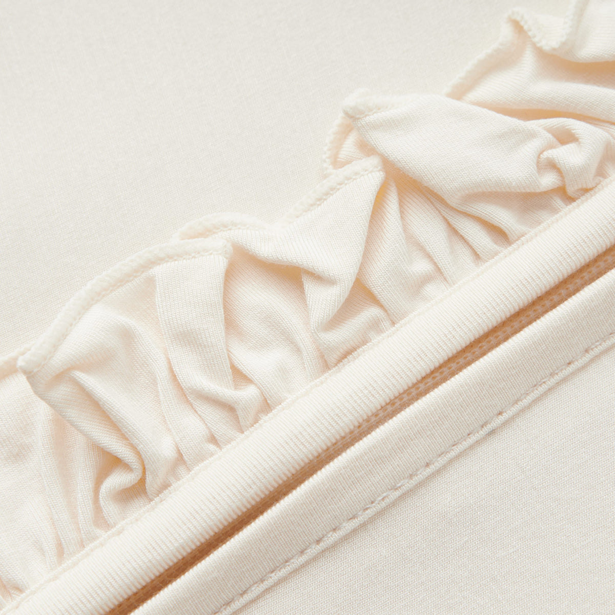 Salt Luxe Solid Ruffle Footed Romper